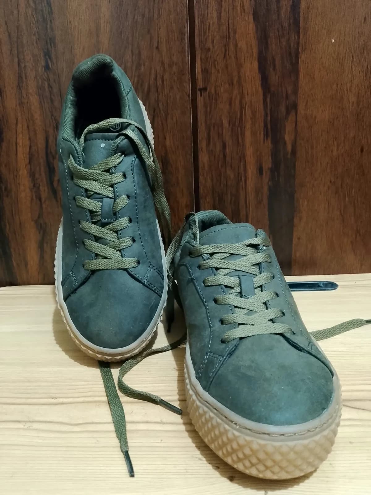Low top sneaker, olive green, flaw close up