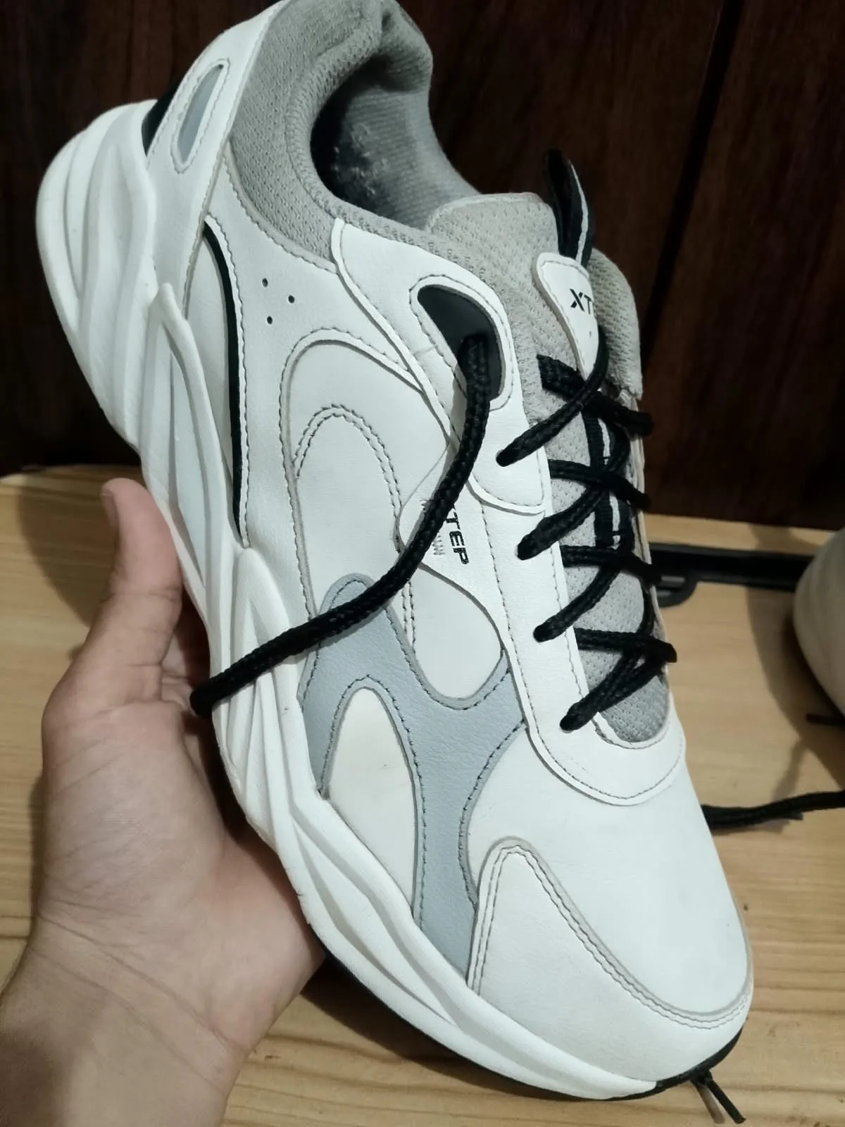 XTEP trainer, white and grey, side profile
