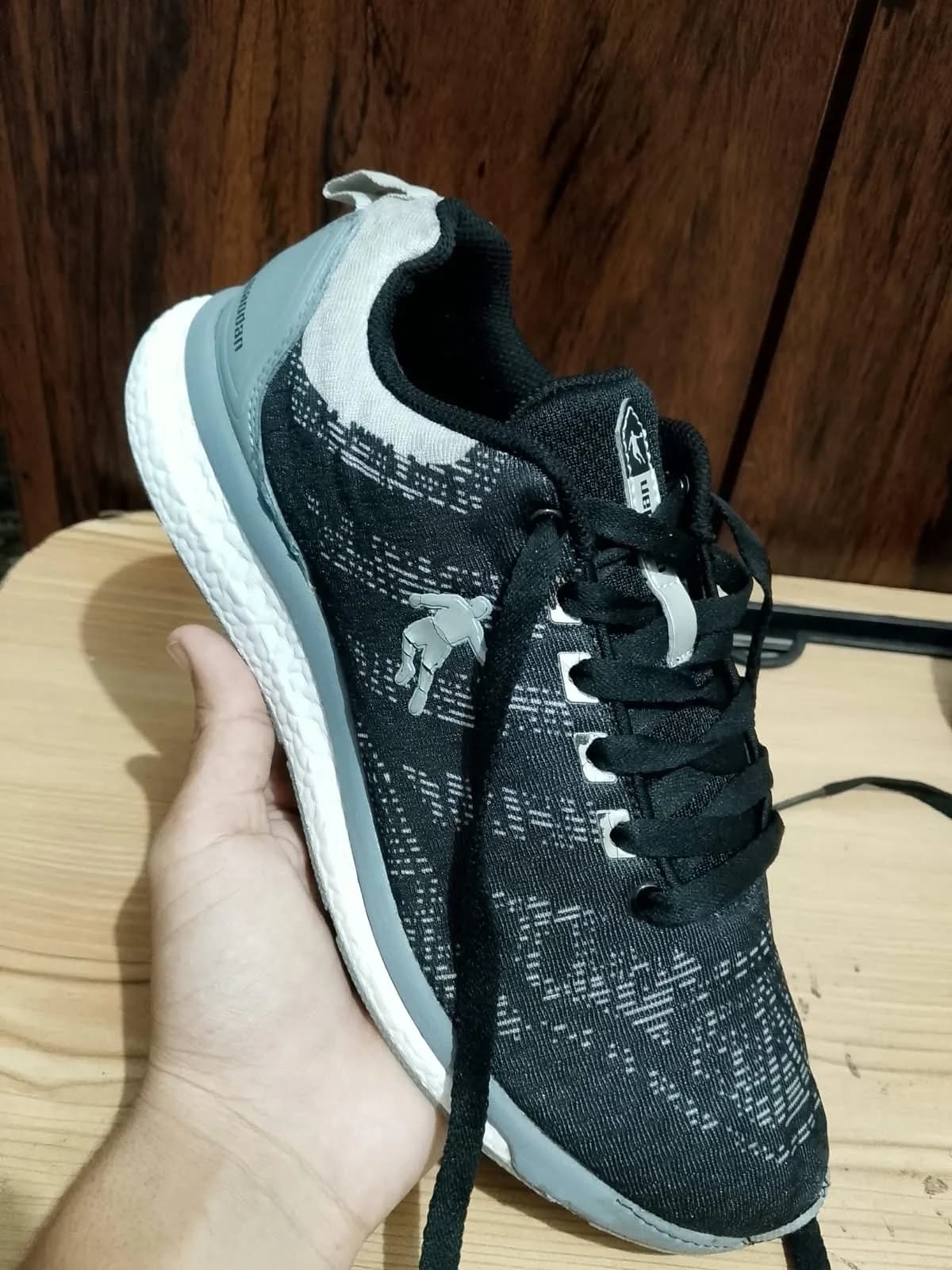 Running shoe, black and grey, side profile