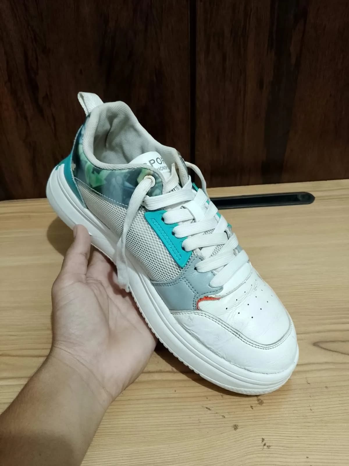 Low top sneaker, white and teal, side profile